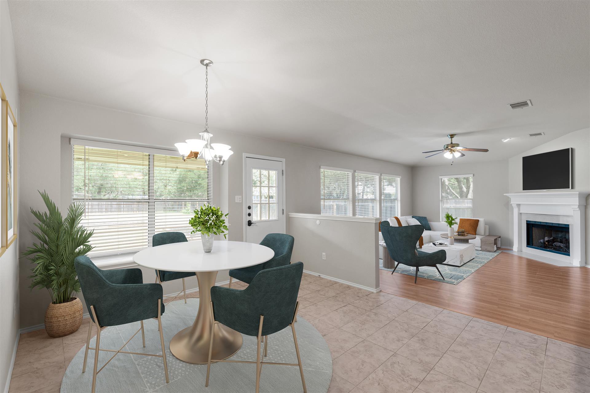 4725 Tello Path Austin, TX 78749 - Photo 6 of 34 An inviting eat-in kitchen flows seamlessly into a comfortable living space, featuring a fireplace and lustrous wood flooring.