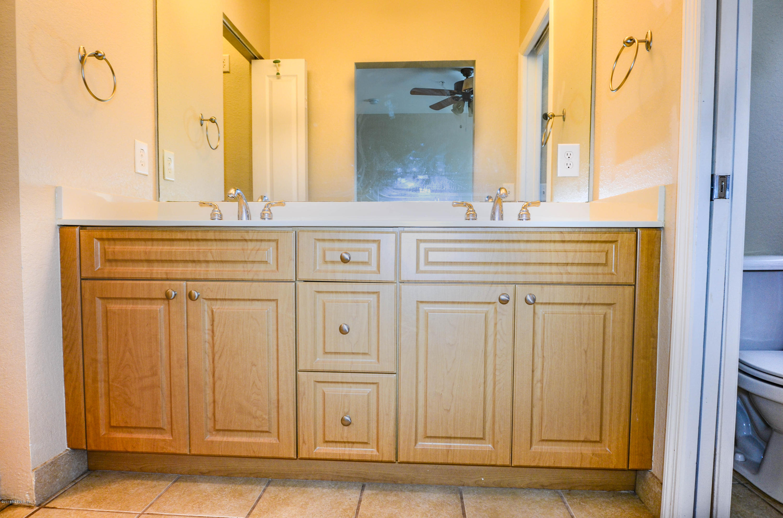 9745 Touchton Road, Unit 1829 Jacksonville, FL 32246 - Photo 13 of 37 a bathroom with a double vanity sink and a mirror