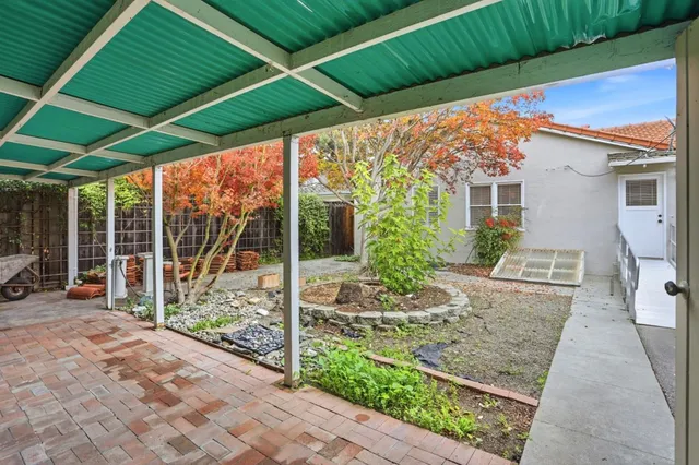 a view of backyard with furniture and garden