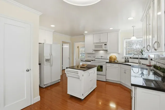 a kitchen with cabinets and stainless steel appliances