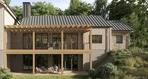 a view of a house with backyard and sitting area