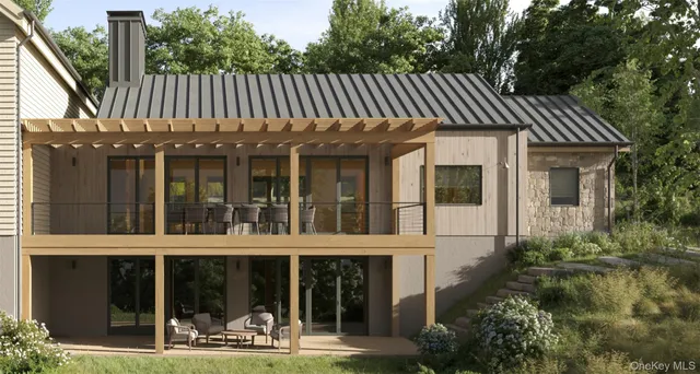 a view of a house with backyard and sitting area