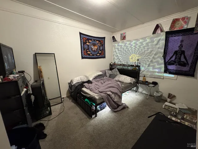 a living room with furniture a flat screen tv and a wall painting