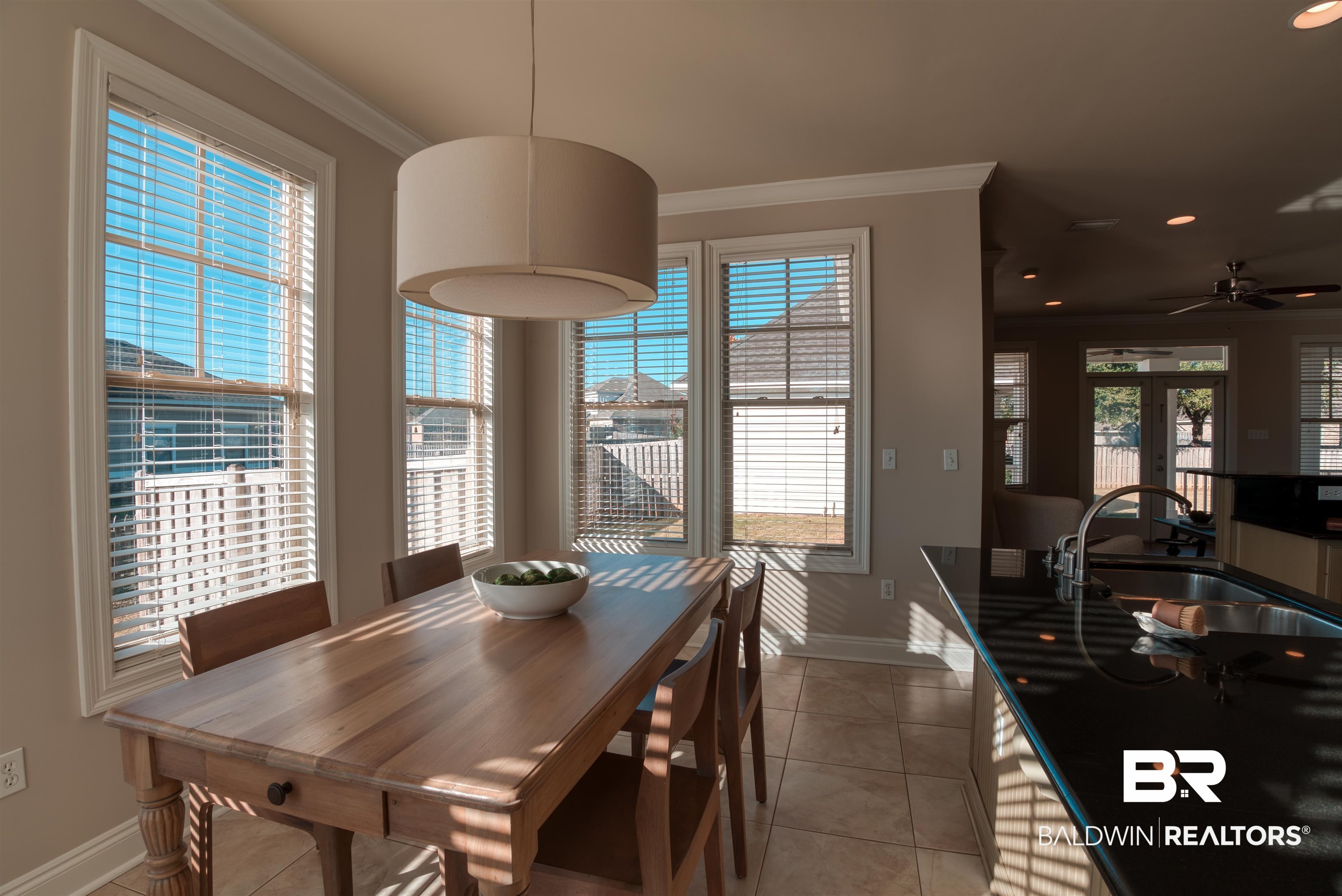 24561 Austin Road Daphne, AL 36526 - Photo 14 of 57 Dining area with a healthy amount of sunlight, ornamental molding, sink, and french doors