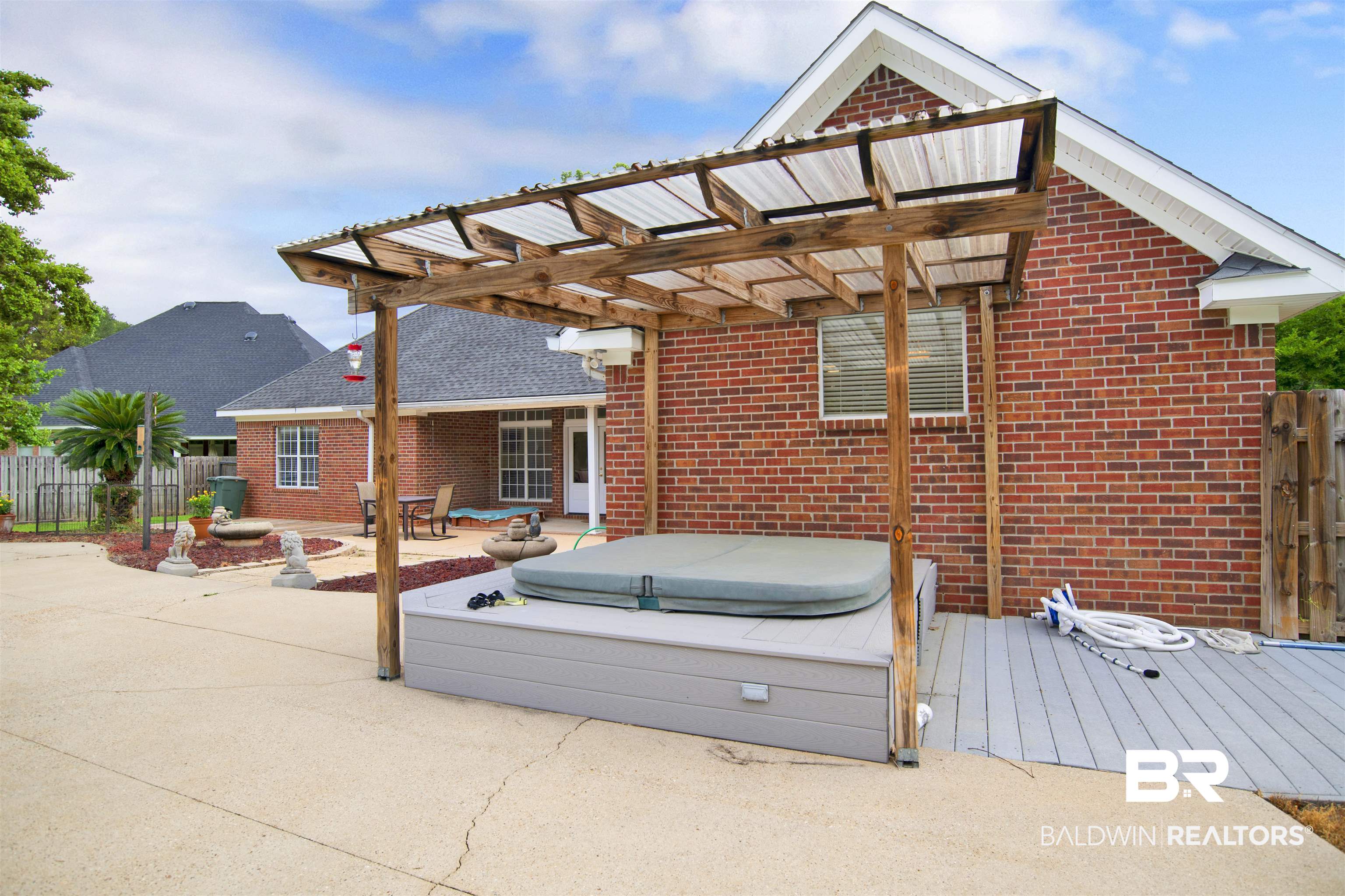 8847 Dawes Lake Road South Mobile, AL 36619 - Photo 42 of 47 Private backyard featuring a hot tub with a wood and clear panel pergola