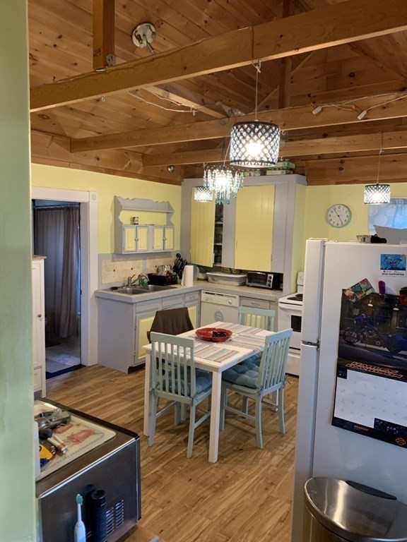 11 Bates Hill Road Sturbridge, MA 01518 - Photo 3 of 7 a kitchen with stainless steel appliances granite countertop a stove a refrigerator and a dining table