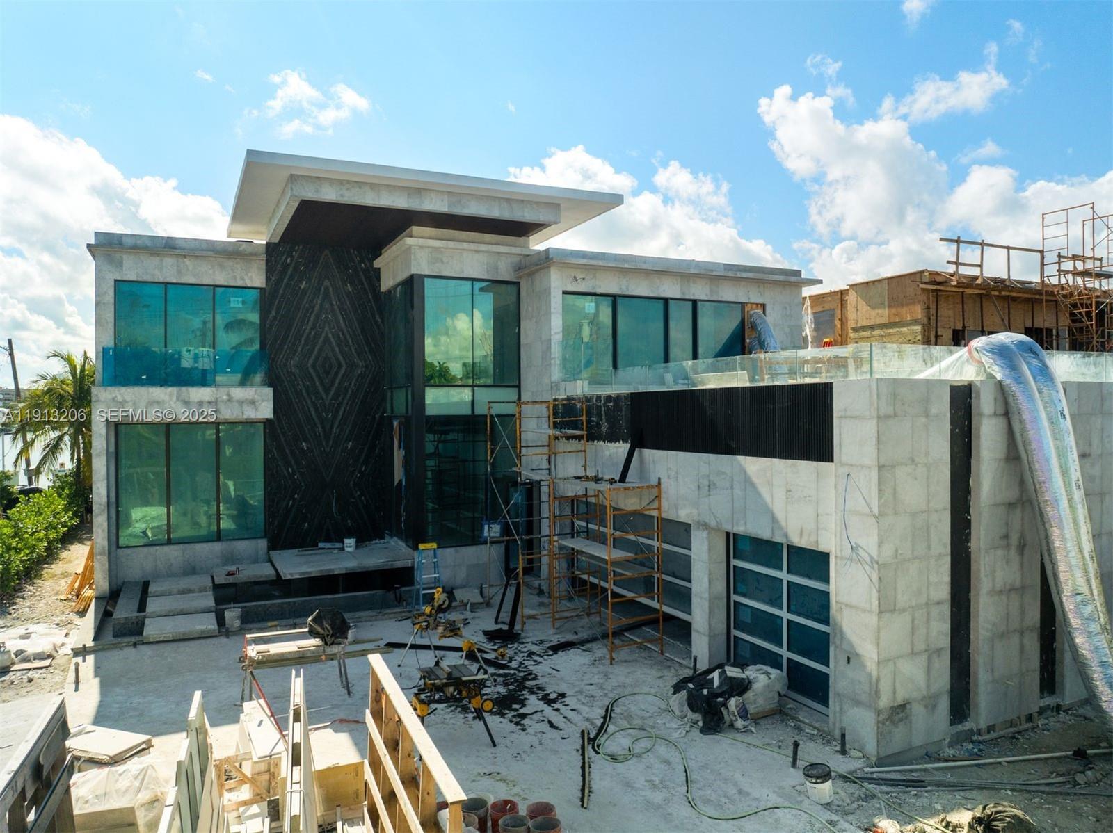 600 88th Street Surfside, FL 33154 - Photo 20 of 27 a front view of a house with garden
