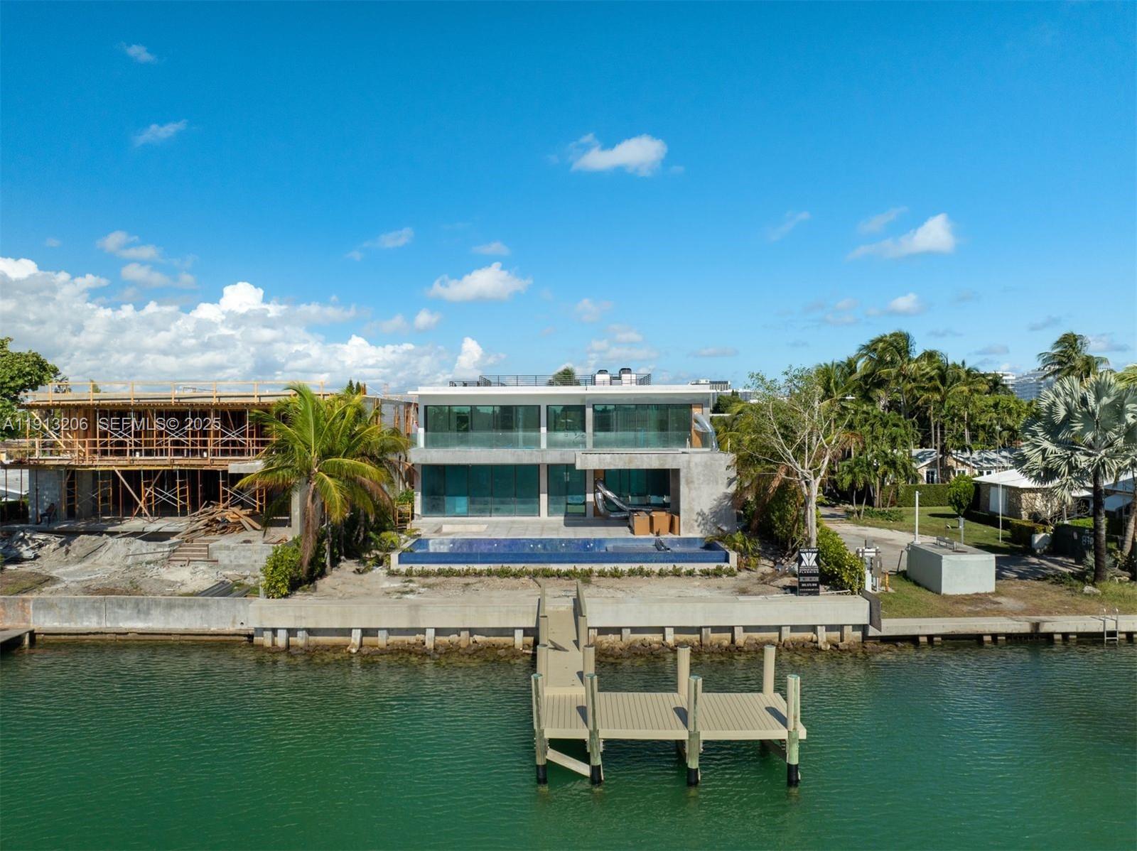 600 88th Street Surfside, FL 33154 - Photo 22 of 27 a swimming pool with outdoor seating and yard