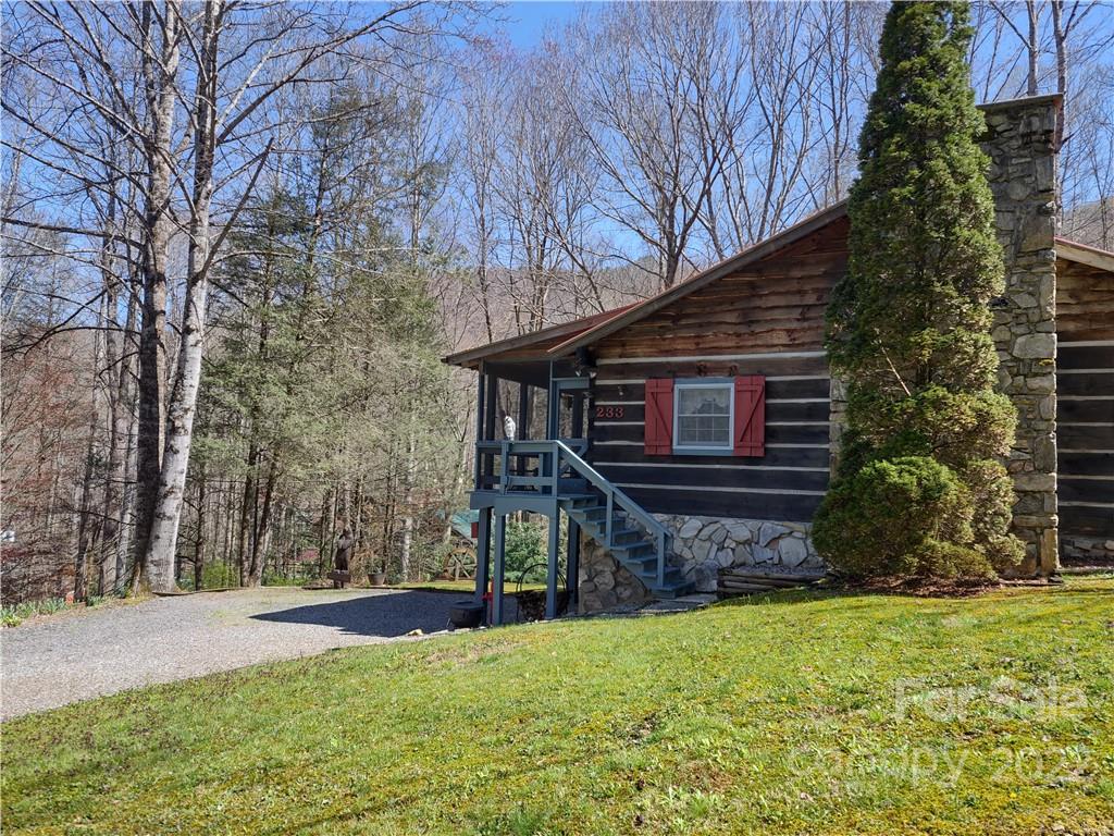 233 Nottingham Road Maggie Valley, NC 28751 - Photo 1 of 44 a view of a house with backyard and wooden fence