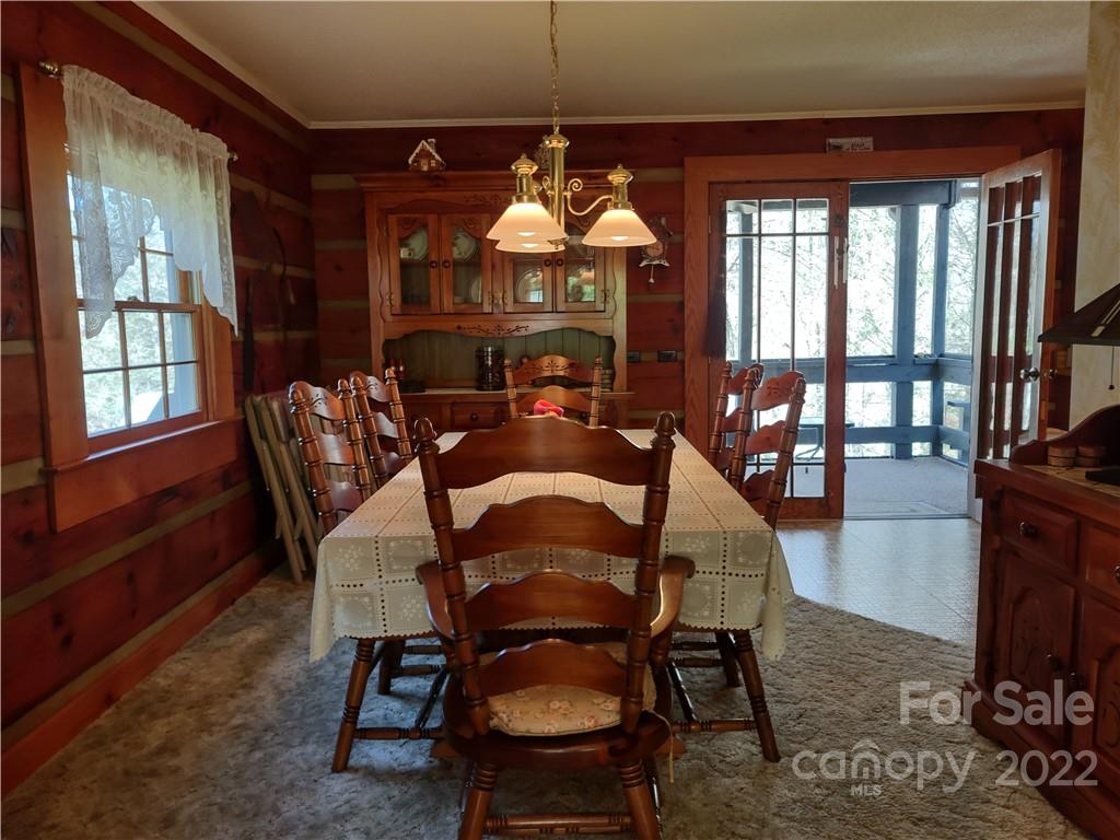 233 Nottingham Road Maggie Valley, NC 28751 - Photo 13 of 44 a view of a dining room with furniture window and wooden floor
