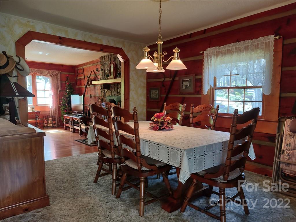233 Nottingham Road Maggie Valley, NC 28751 - Photo 14 of 44 a view of a dining room with furniture and chandelier