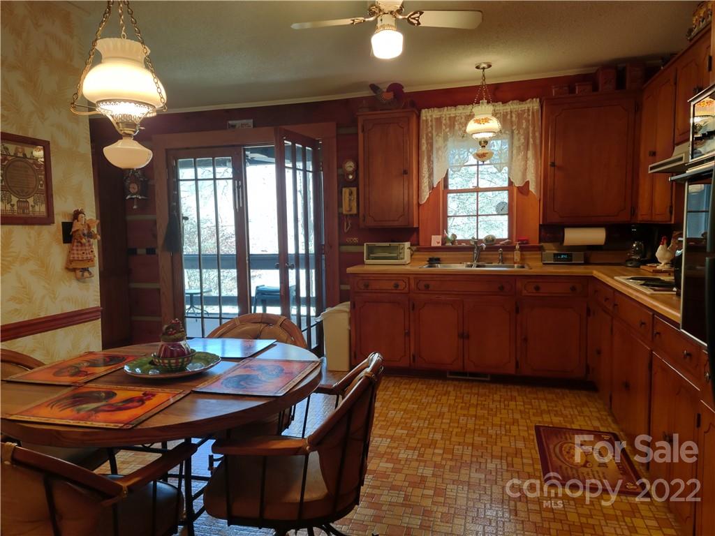 233 Nottingham Road Maggie Valley, NC 28751 - Photo 18 of 44 a kitchen with stainless steel appliances granite countertop a sink a stove a dining table and chairs