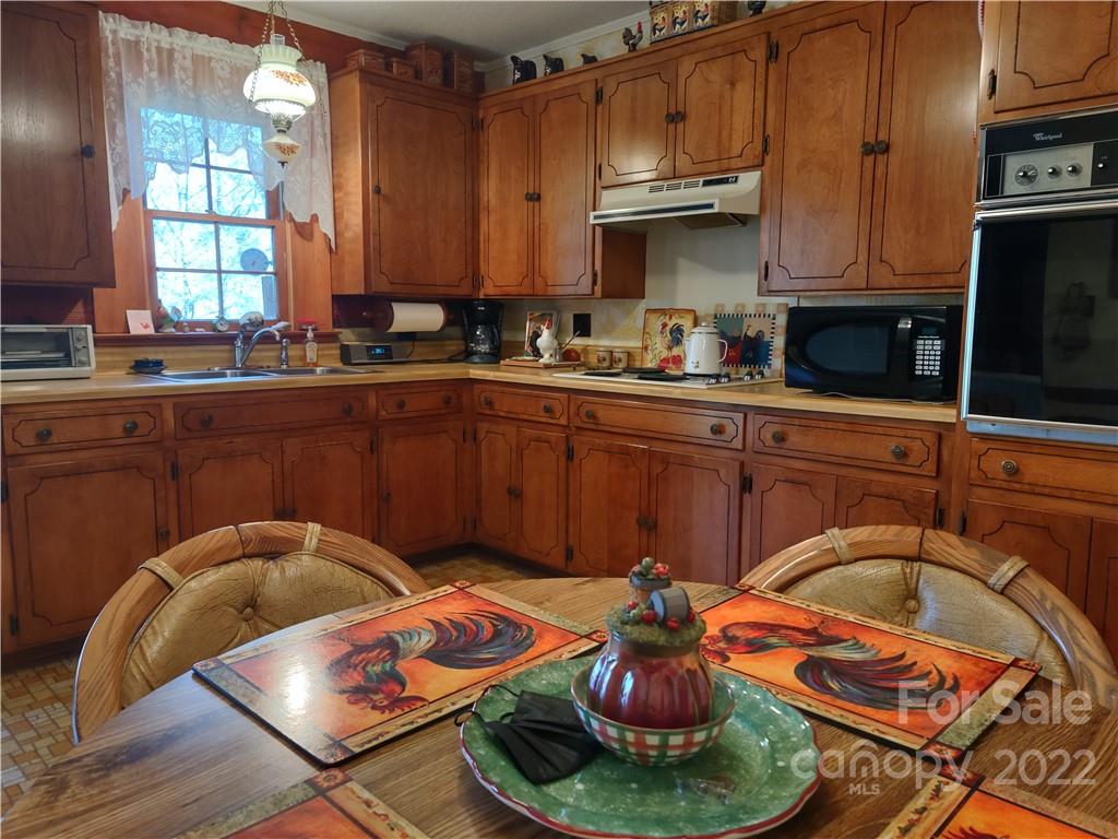 233 Nottingham Road Maggie Valley, NC 28751 - Photo 19 of 44 a kitchen with stainless steel appliances granite countertop a sink and cabinets
