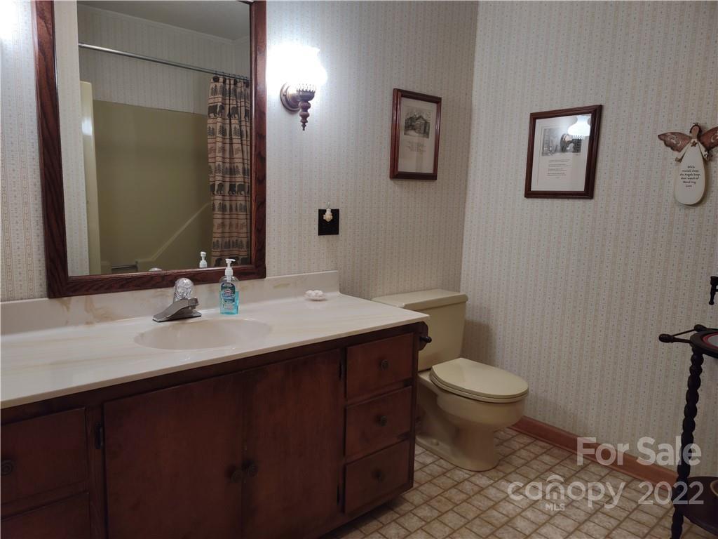 233 Nottingham Road Maggie Valley, NC 28751 - Photo 21 of 44 a bathroom with a sink toilet and mirror