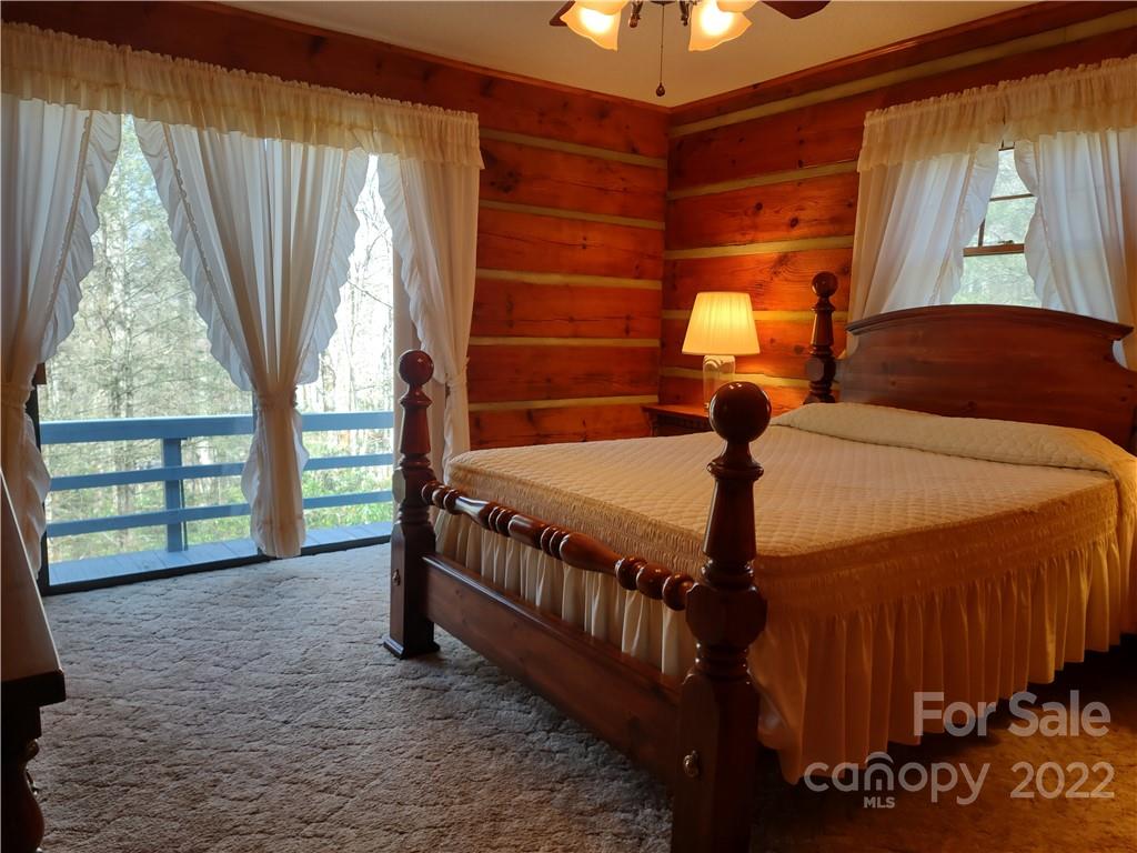 233 Nottingham Road Maggie Valley, NC 28751 - Photo 24 of 44 a bedroom with a bed and a large window
