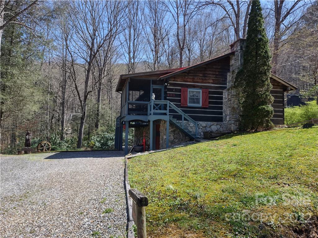 233 Nottingham Road Maggie Valley, NC 28751 - Photo 3 of 44 a view of a house with backyard and trees