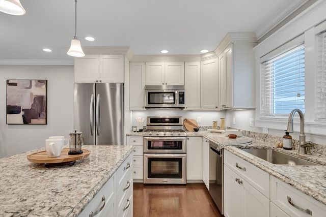 a kitchen with a sink stove and refrigerator
