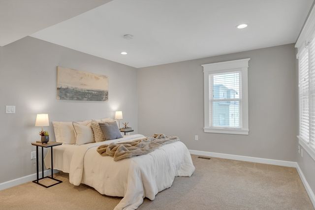 a bedroom with a bed and a night stand