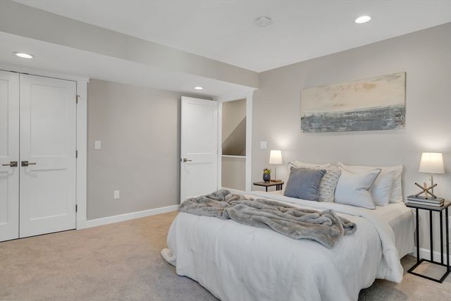 a bedroom with a bed and a painting