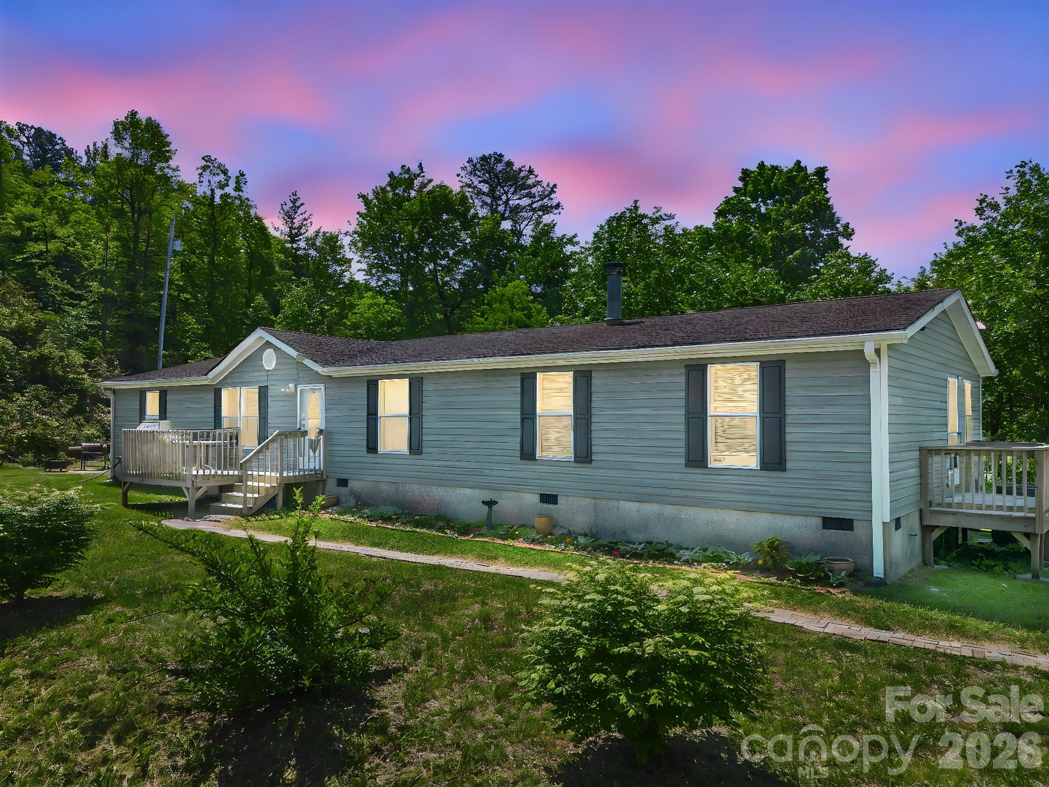 2053 Nancy Mountain Road Rosman, NC 28772 - Photo 2 of 47 a house view with a garden space