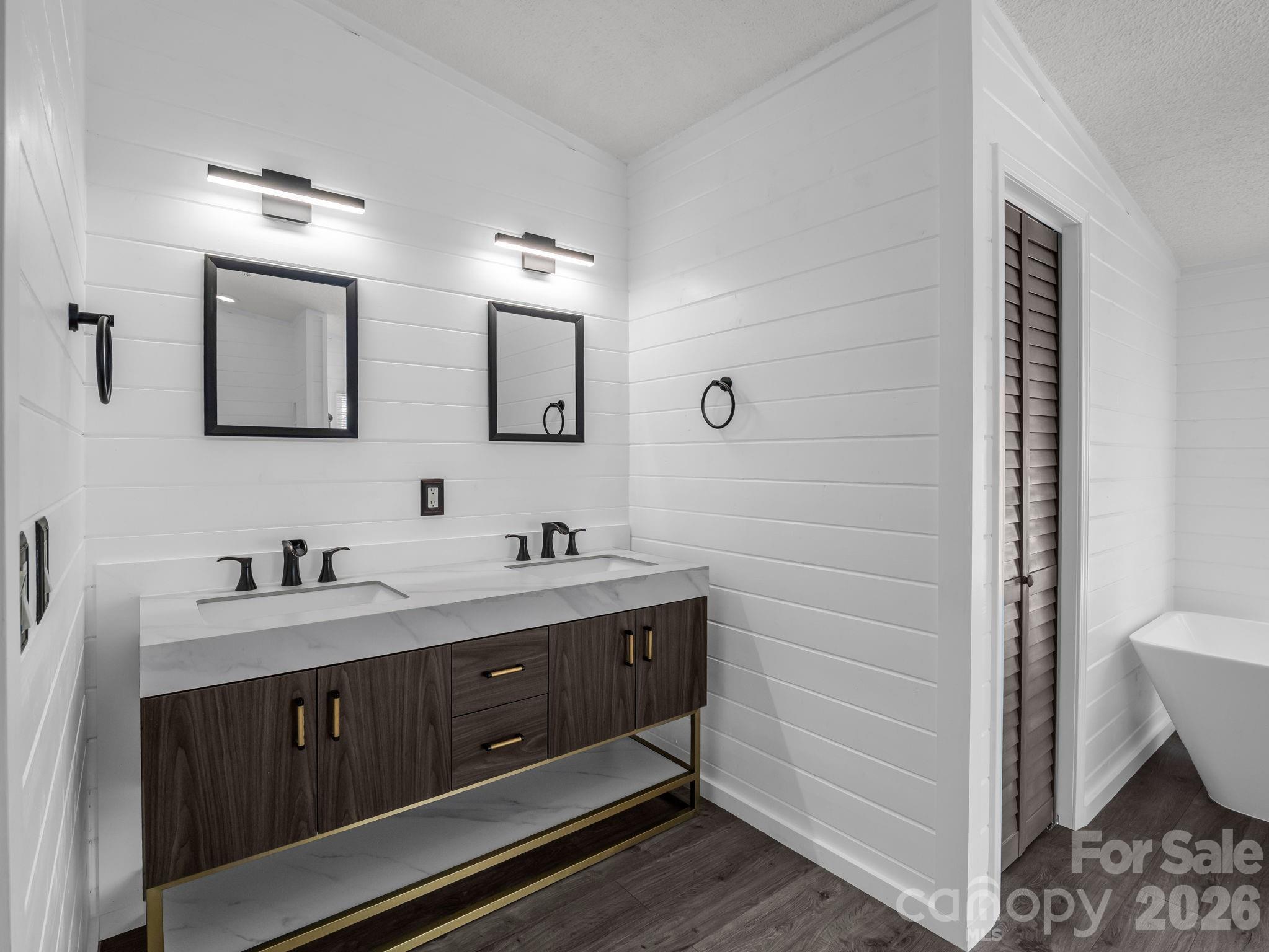 2053 Nancy Mountain Road Rosman, NC 28772 - Photo 27 of 47 a bathroom with a double vanity sink a toilet and mirror