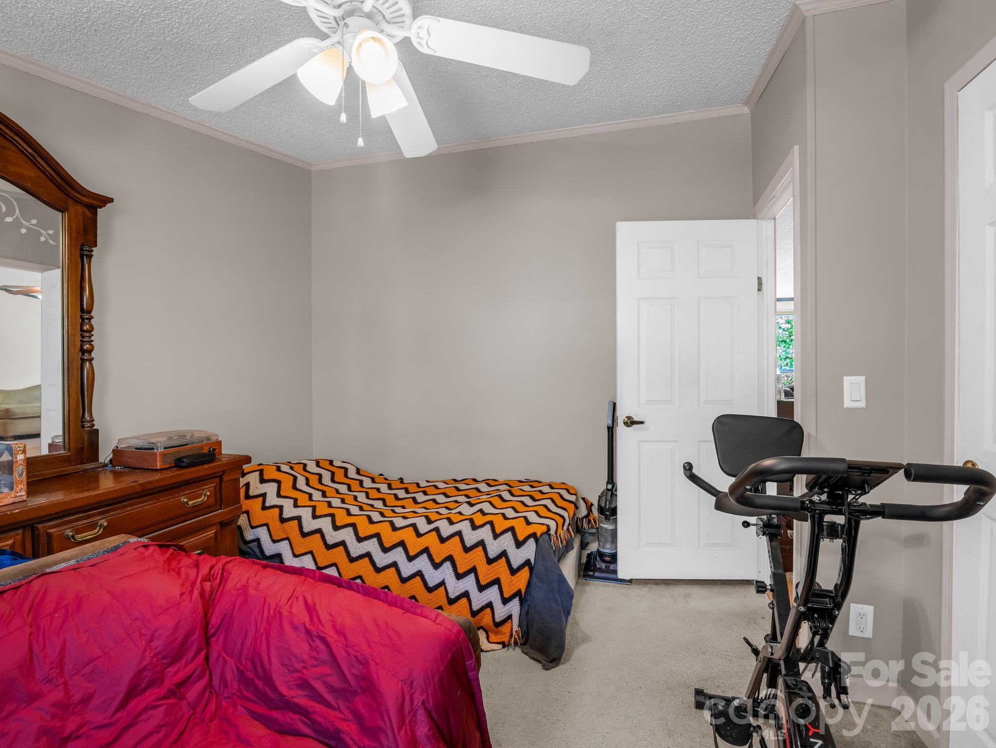 2053 Nancy Mountain Road Rosman, NC 28772 - Photo 36 of 47 a bedroom with a bed and a chandelier