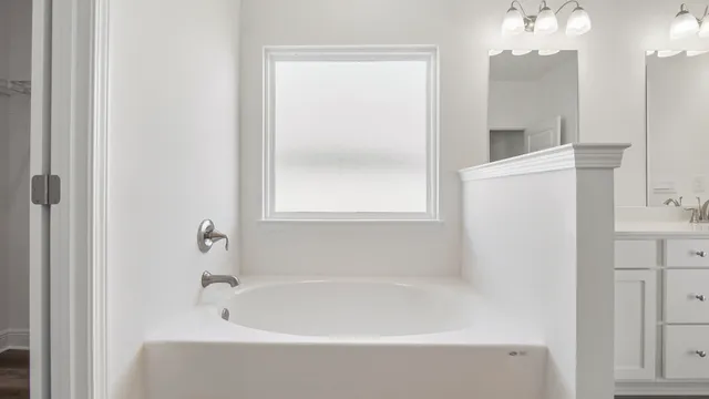 a white bath tub sitting next to a white sink