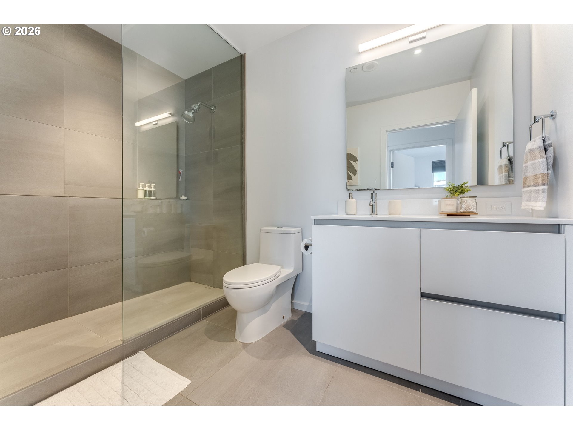 1150 Northwest Quimby Street, Unit 406 Portland, OR 97209 - Photo 19 of 48 a bathroom with a sink a toilet and shower