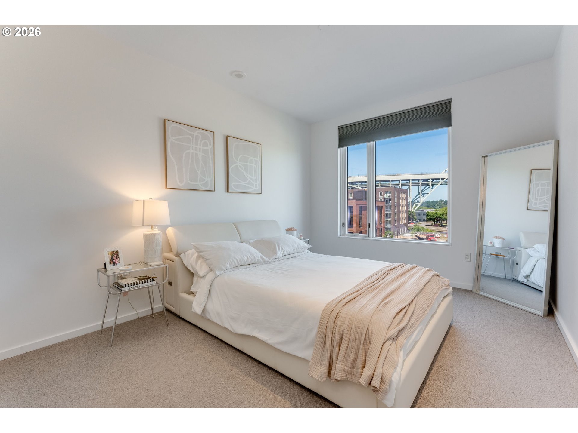 1150 Northwest Quimby Street, Unit 406 Portland, OR 97209 - Photo 20 of 48 a bedroom with a bed and a lamp