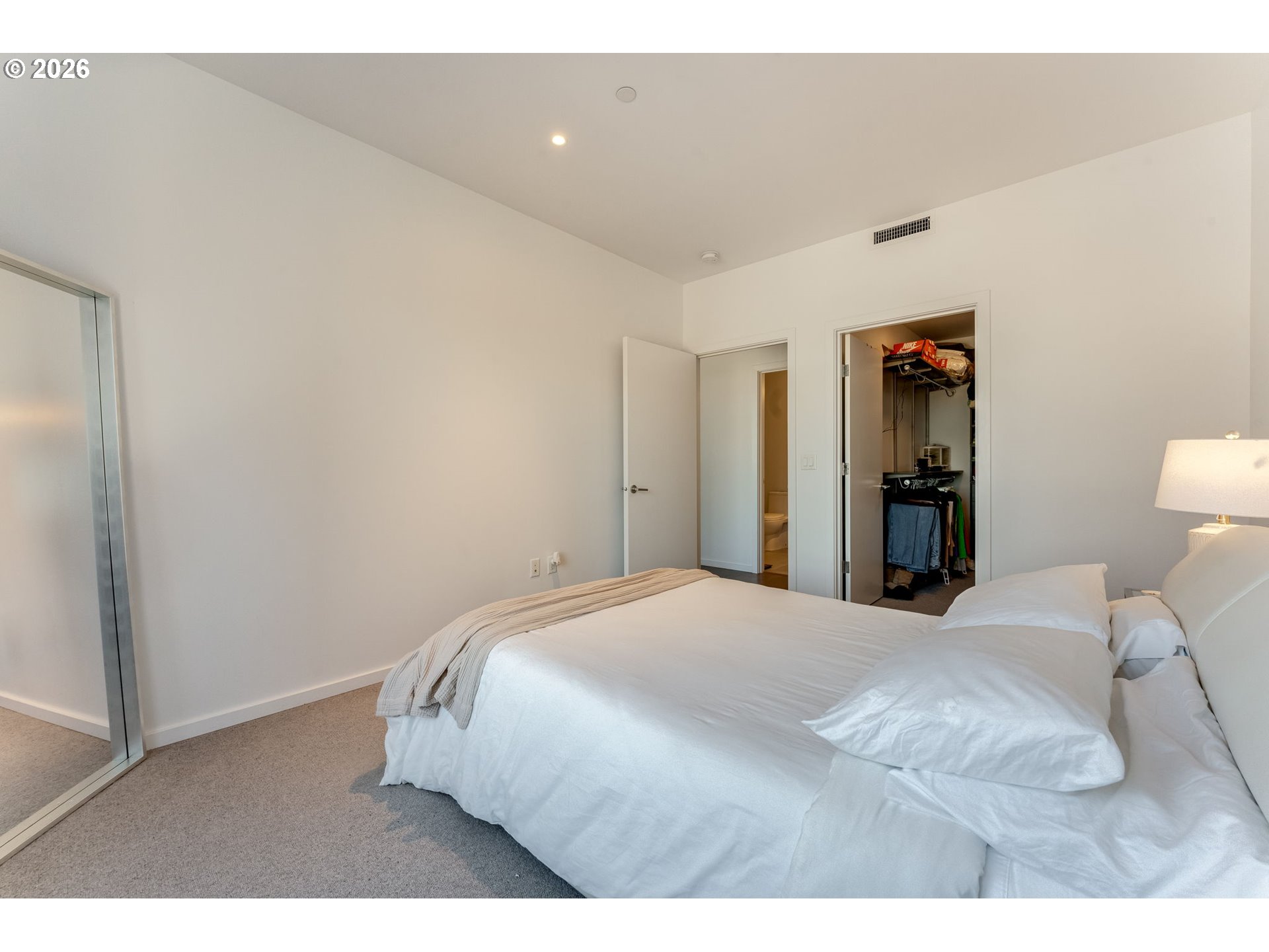 1150 Northwest Quimby Street, Unit 406 Portland, OR 97209 - Photo 21 of 48 a bedroom with a bed and a closet