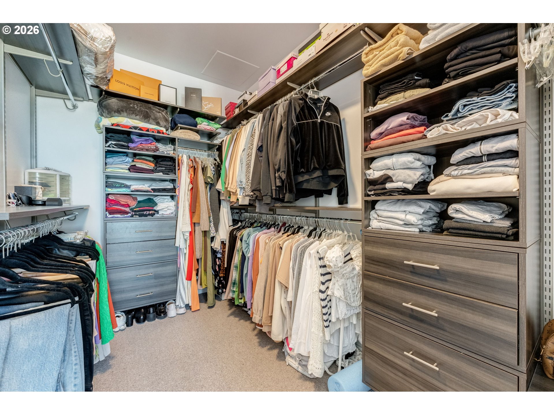 1150 Northwest Quimby Street, Unit 406 Portland, OR 97209 - Photo 22 of 48 a view of walk in closet with clothes and shoes