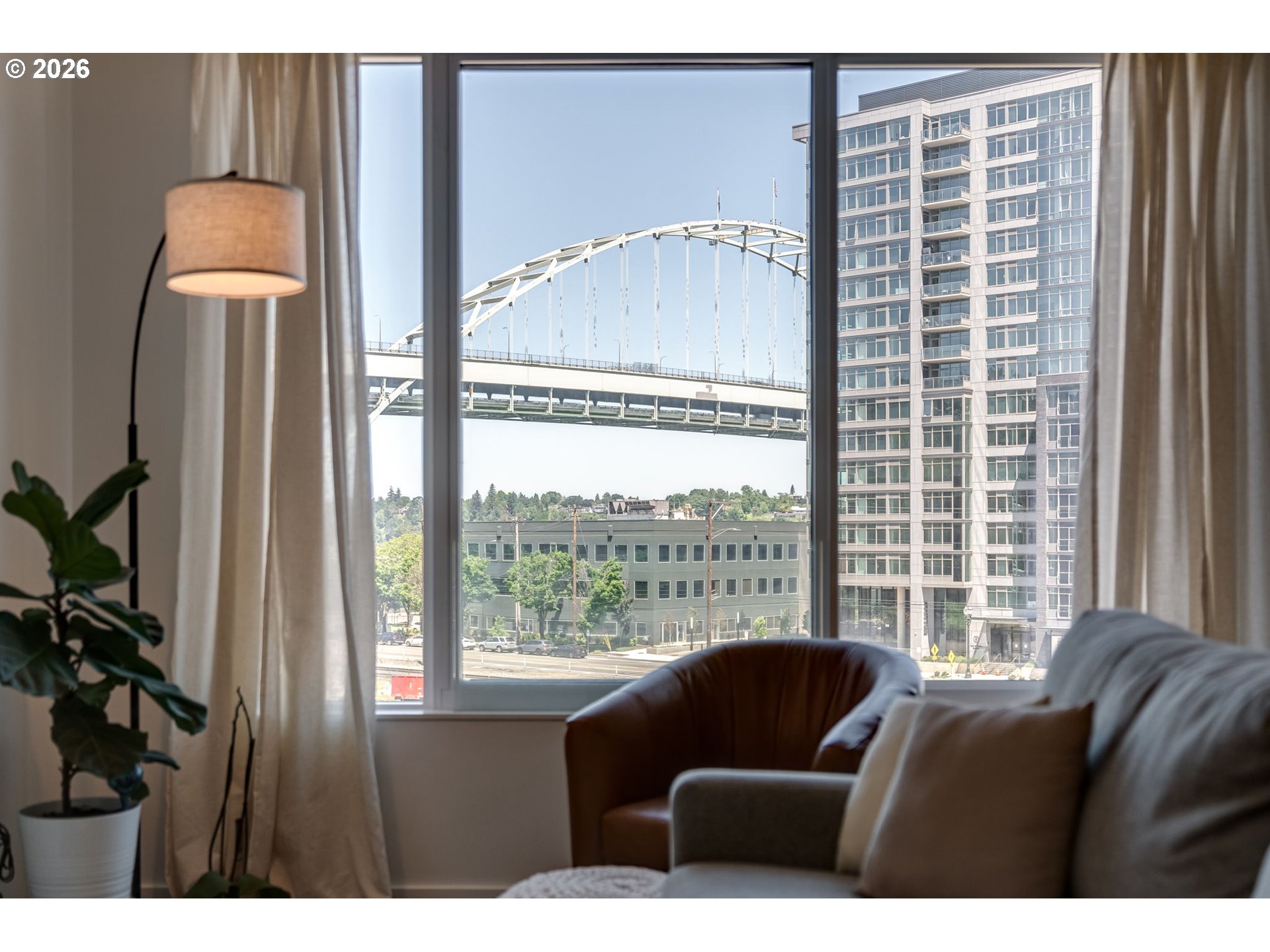 1150 Northwest Quimby Street, Unit 406 Portland, OR 97209 - Photo 24 of 48 a living room with furniture and a window