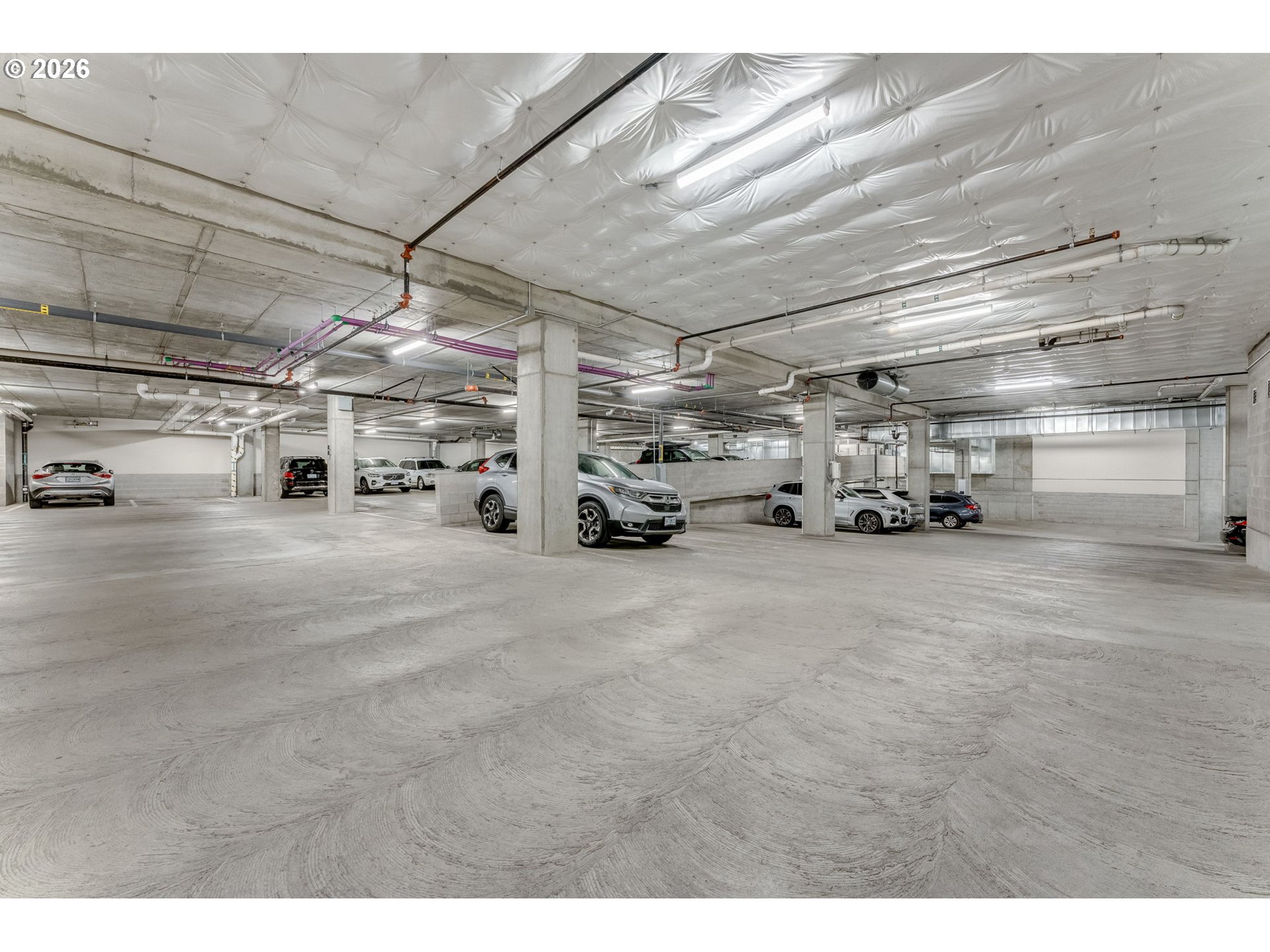 1150 Northwest Quimby Street, Unit 406 Portland, OR 97209 - Photo 34 of 48 a view of parking garage with cars