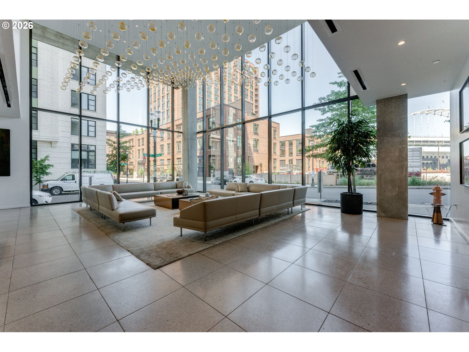 1150 Northwest Quimby Street, Unit 406 Portland, OR 97209 - Photo 6 of 48 a lobby with furniture and floor to ceiling window