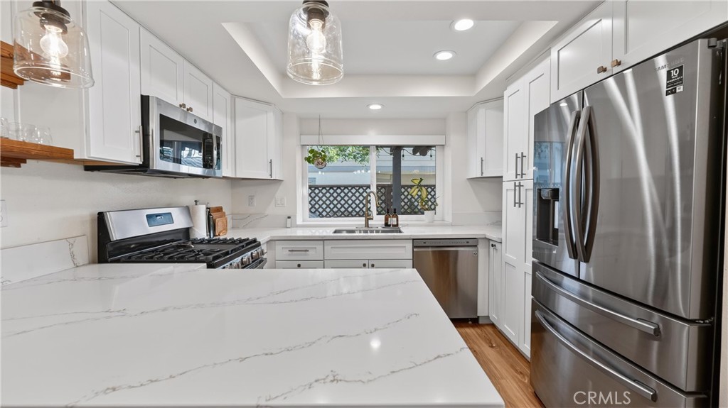 1761 Forum Way, Unit D Corona, CA 92881 - Photo 11 of 39 a kitchen with stainless steel appliances a refrigerator sink and microwave