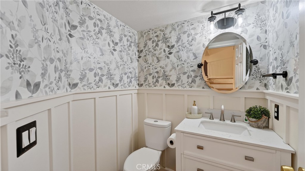 1761 Forum Way, Unit D Corona, CA 92881 - Photo 15 of 39 a bathroom with a sink mirror vanity and toilet