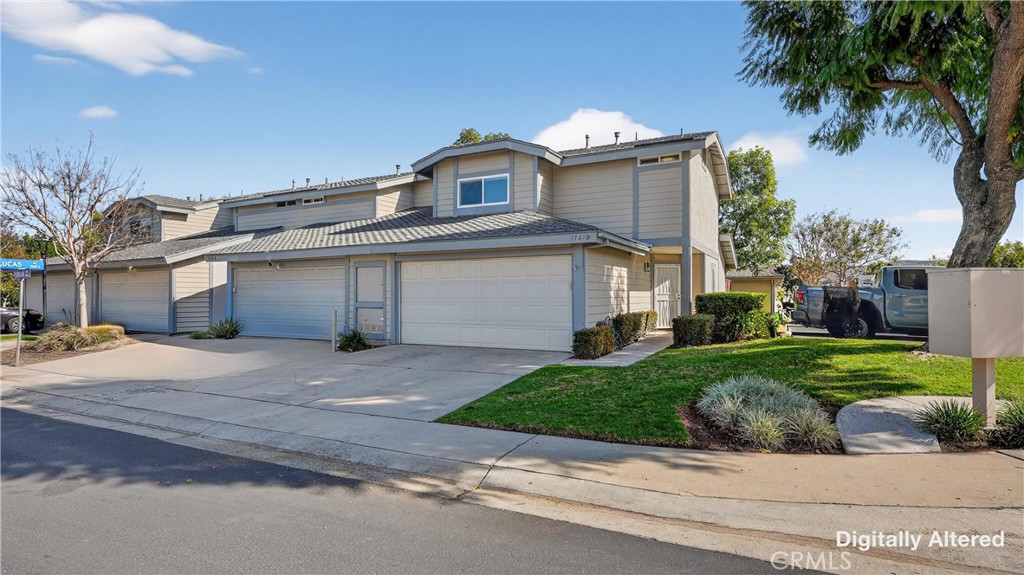 1761 Forum Way, Unit D Corona, CA 92881 - Photo 2 of 39 a front view of a house with a yard and garage