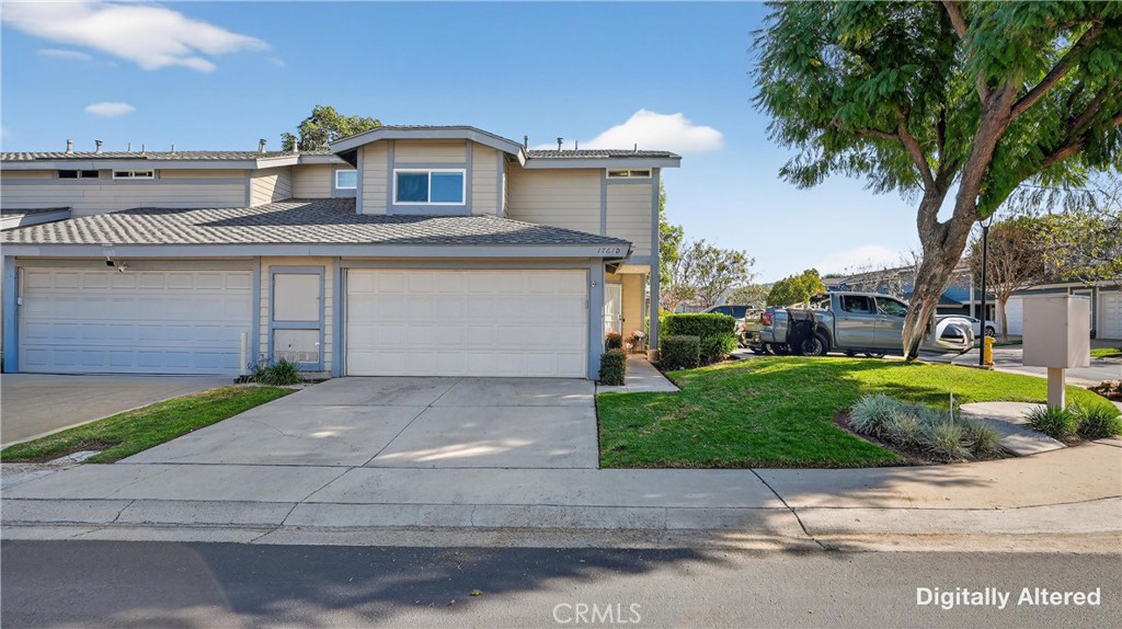 1761 Forum Way, Unit D Corona, CA 92881 - Photo 33 of 39 a front view of a house with a yard and a garage