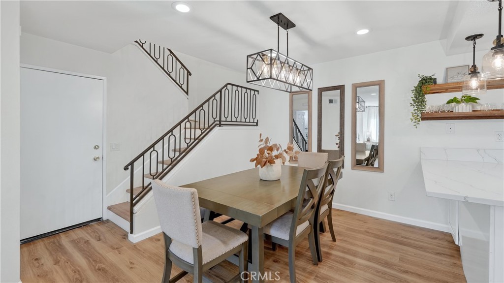 1761 Forum Way, Unit D Corona, CA 92881 - Photo 10 of 39 a view of a dining room with furniture wooden floor and chandelier