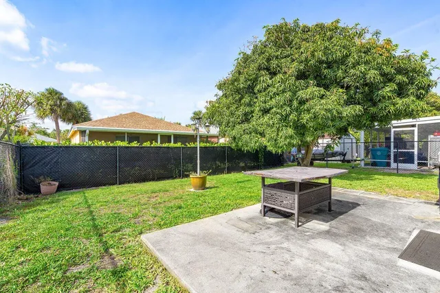 a view of a house with a backyard and a patio