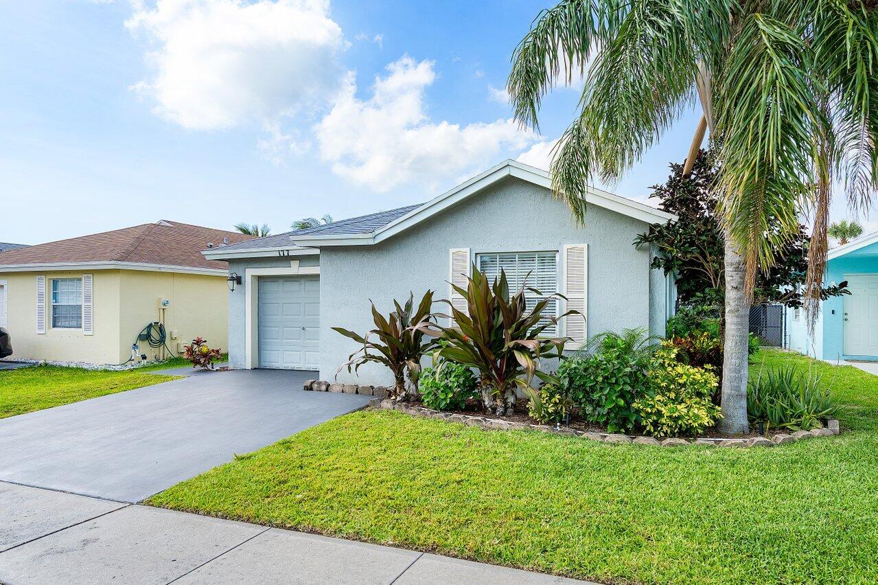 177 Heming Way Boynton Beach, FL 33426 - Photo 2 of 22 a front view of a house with garden