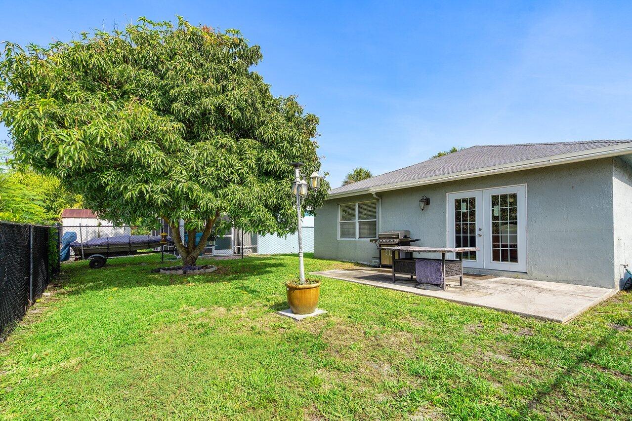 177 Heming Way Boynton Beach, FL 33426 - Photo 21 of 22 a view of a house with a backyard and a patio