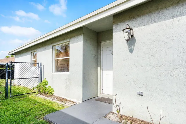 a view of a small house with a yard