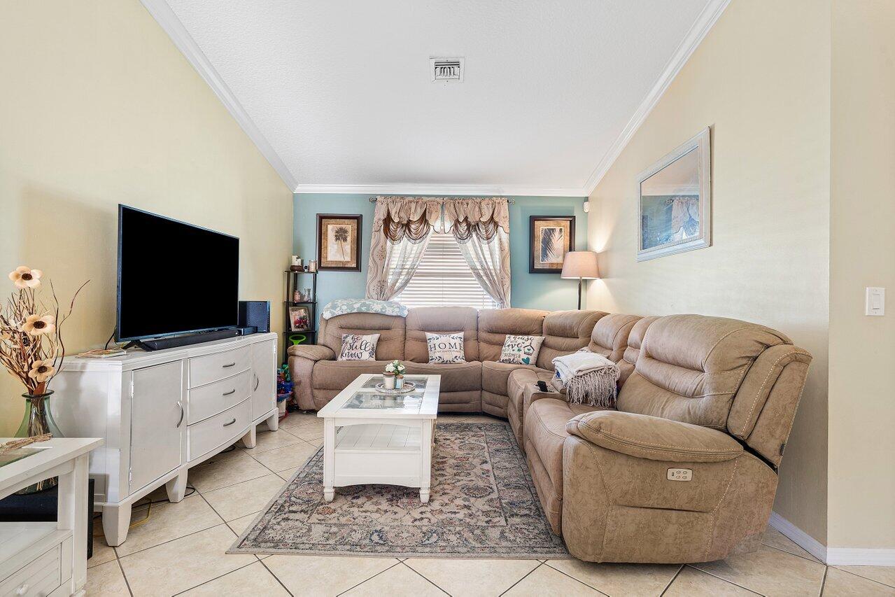 177 Heming Way Boynton Beach, FL 33426 - Photo 5 of 22 a living room with furniture a flat screen tv and a chandelier