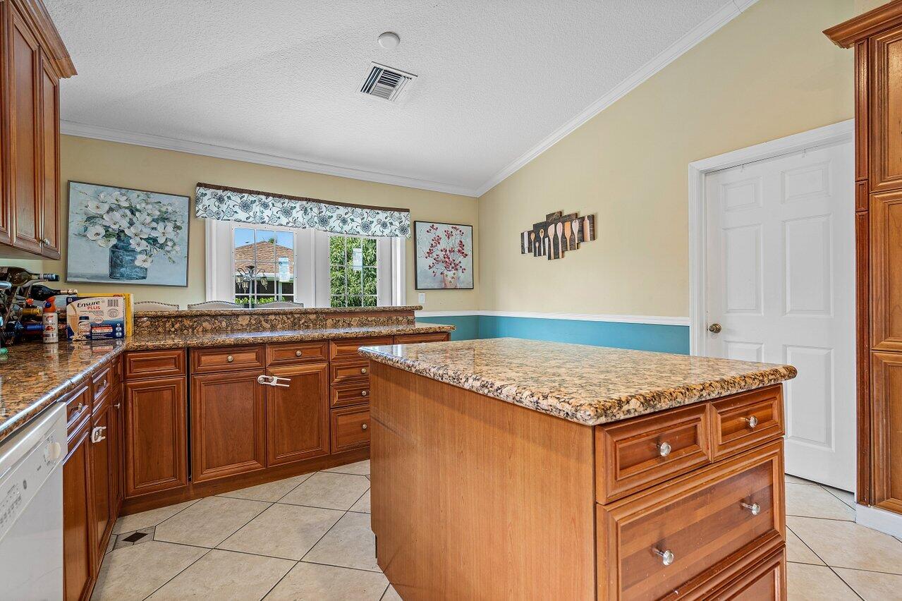 177 Heming Way Boynton Beach, FL 33426 - Photo 8 of 22 a kitchen with stainless steel appliances granite countertop a sink stove and cabinets