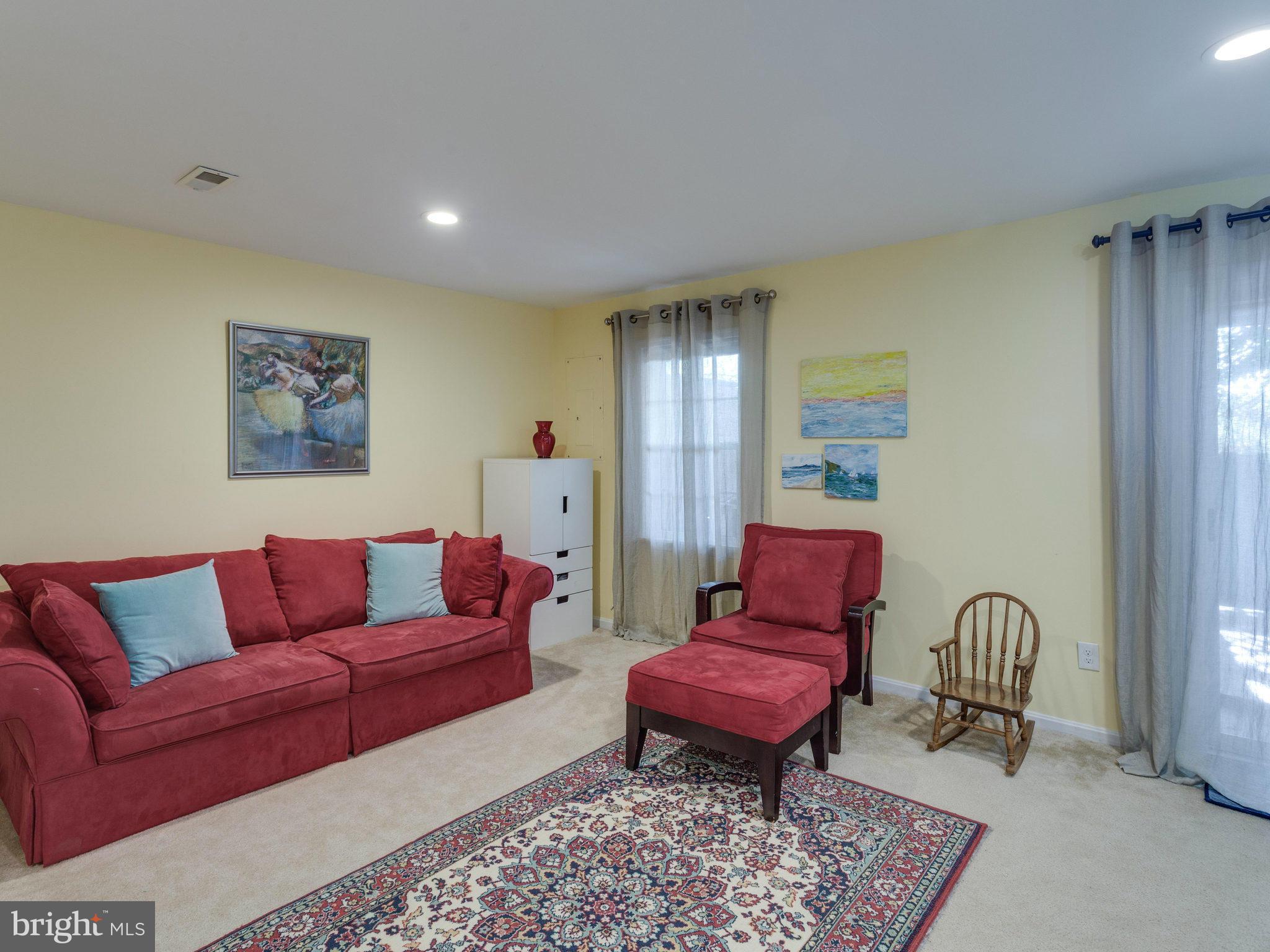 2071 South Glebe Road Arlington, VA 22206 - Photo 14 of 19 a living room with furniture a red lamp and rug
