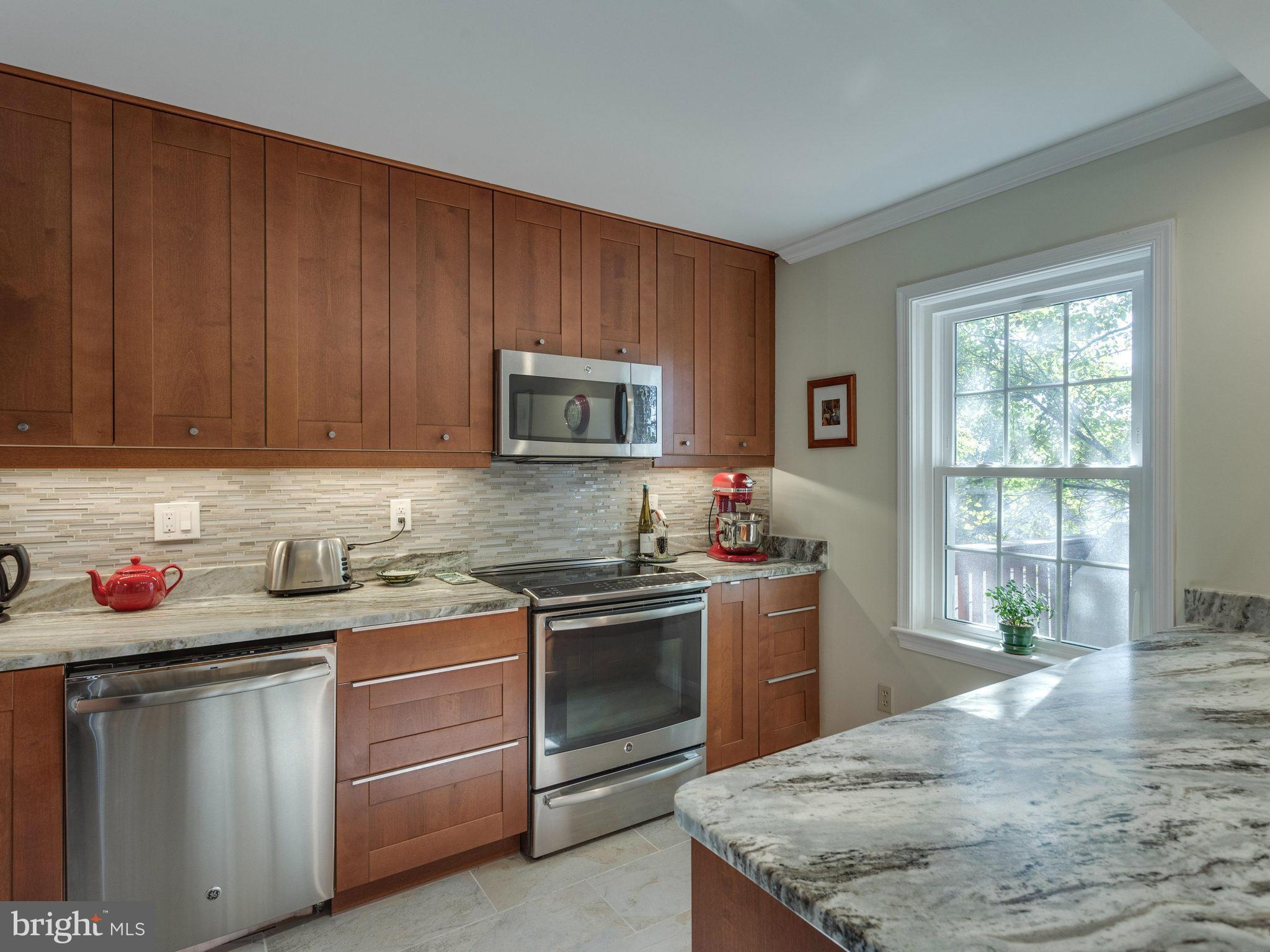 2071 South Glebe Road Arlington, VA 22206 - Photo 6 of 19 a kitchen with stainless steel appliances granite countertop a sink stove and cabinets