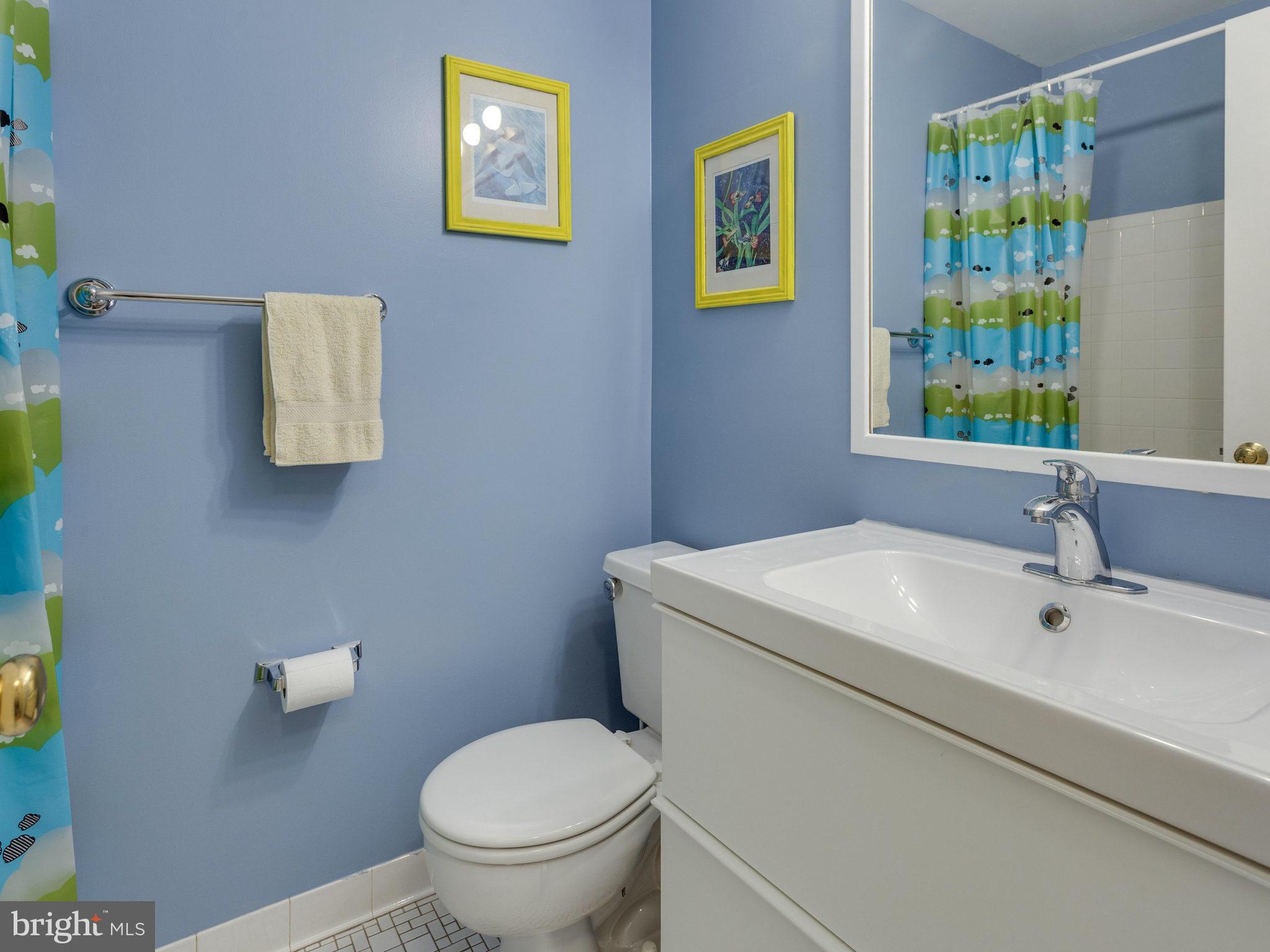 2071 South Glebe Road Arlington, VA 22206 - Photo 9 of 19 a bathroom with a toilet sink and mirror
