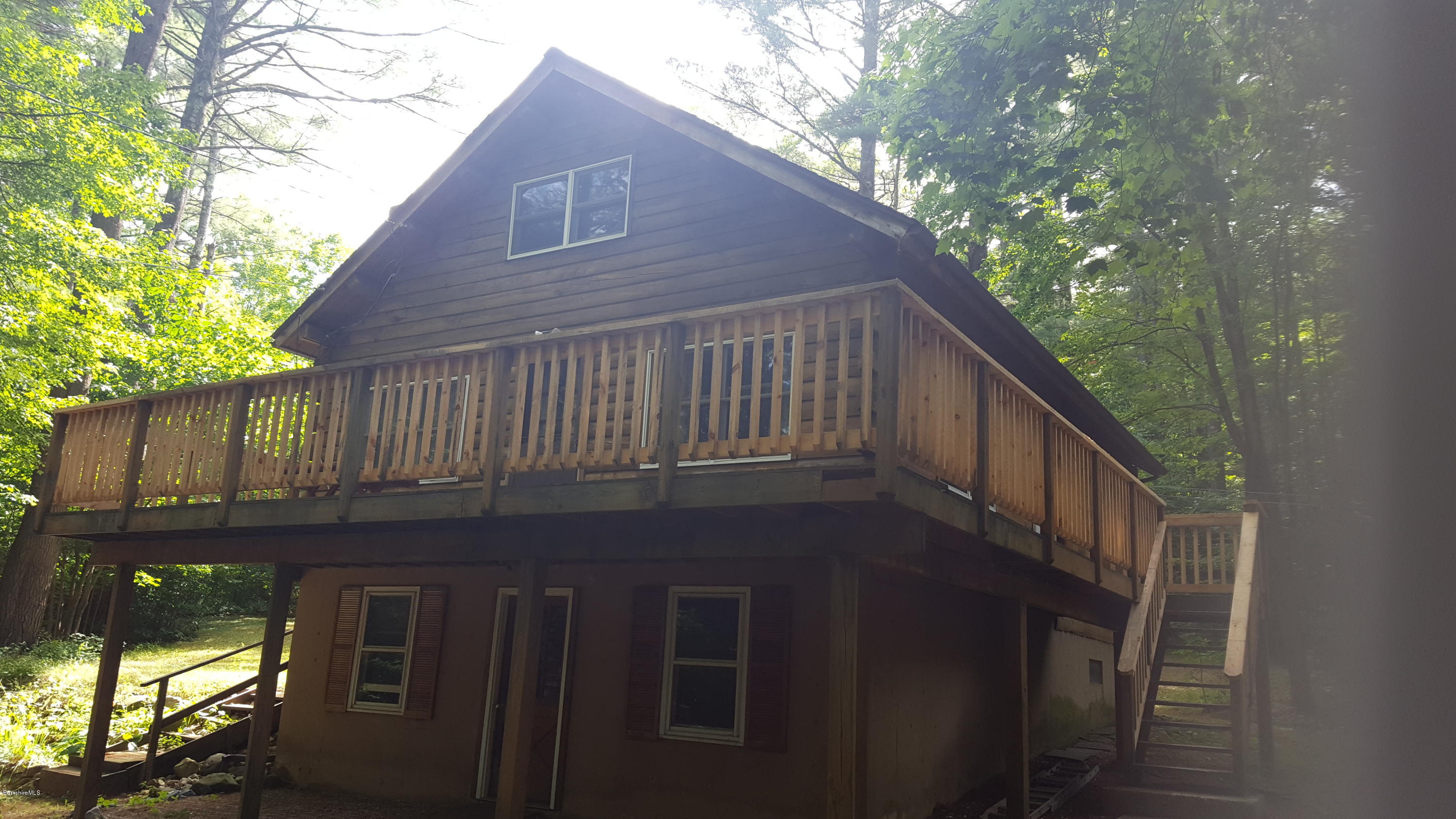 514 South Main Road Otis, MA 01253 - Photo 3 of 21 a backyard of a house with table and sofas