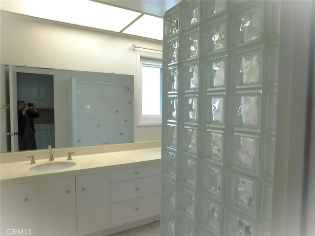 a bathroom with a double vanity sink and mirror